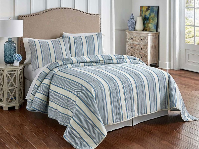 Image of bed with blue and white striped linen set